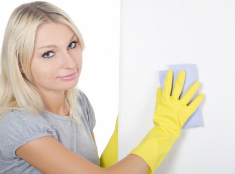 Professional cleaner tidying a shop floor in Highbury